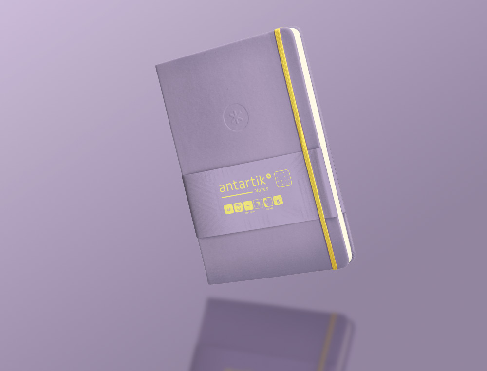 CUADERNO CON GOMILLA ANTARTIK NOTES TAPA DURA A5 HOJAS PUNTOS MORADO Y AMARILLO 100 HOJAS 80 GR FSC
